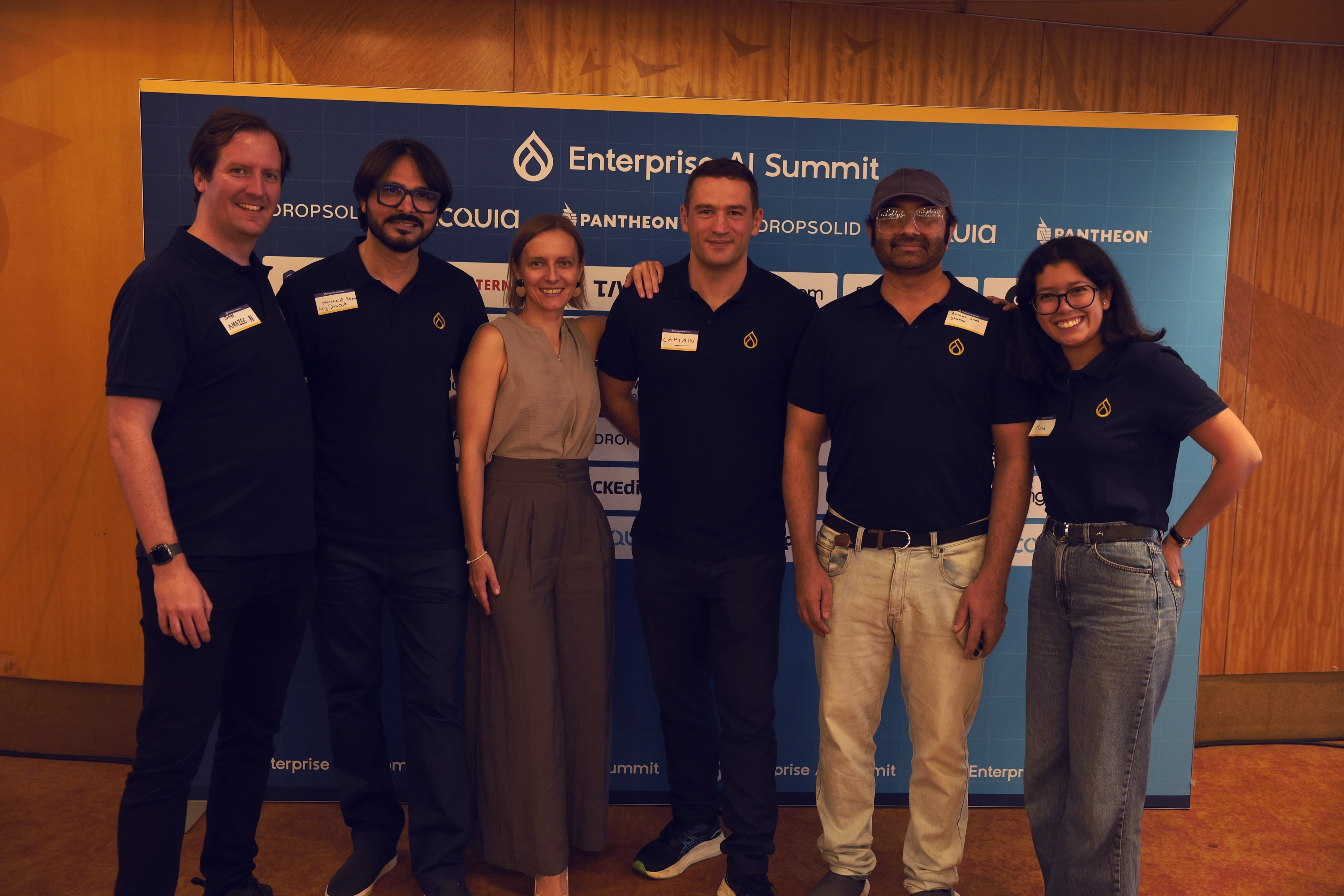 The Enterprise AI Summit team in front of the sponsor backdrop